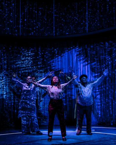 Playwright Sandra Delgado (center, pictured with cast members Charín Álvarez, visible front left; Brian King, visible back left; and Ramón Camín, visible front right) also stars as Clara in HUNDREDS AND HUNDREDS OF STARS.