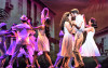 Gloria (Christie Prades) and Emilio Estefan (Mauricio Martinez) dance close in On Your Feet! at the Cadillac Theatre.