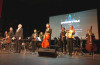 Conductor Eric Roth takes a bow with musicians following the performance.