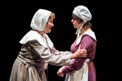 Linda Reiter (left) plays Becky, a descendent of a woman executed for witchcraft in 1692 navigating life in modern-day Salem, and Isabella Maria Valdés is Gail, Becky’s granddaughter, in Shattered Globe Theatre’s Midwest premiere of Becky Nurse of Salem by Sarah Ruhl.