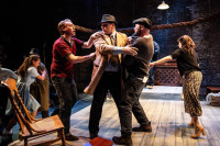 (center, from left) Rodolfo (Harrison Weger tries to pull an Immigration Officer (Adam Schulmerich) away from his brother Marco (Mike Cherry), as Catherine (Isabelle Muthiah, left) and Beatrice (Eileen Niccolai) struggle to stop their arrest in Shattered Globe Theatre’s A View From the Bridge. Louis Contey directs Arthur Miller’s classic drama, opening Shattered Globe’s 33rd season September 8-October 21 at Theater Wit, 1229 W. Belmont Ave., Chicago. For tickets, visit sgtheatre.org, call the Theater Wit box office (773) 975-8150, or buy in person at Theater Wit.