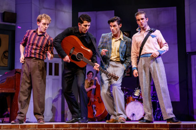 left to right - Michael Kurowski as Jerry Lee Lewis, Tommy Malouf as Johnny Cash, Michael Sinclair as Brother Jay (background), Zachary Stevenson as Carl Perkins and Zach Sorrow as Elvis Presley in Million Dollar Quartet at Theater at the Center